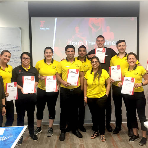 Fitness First employees holding their certificates after a training session