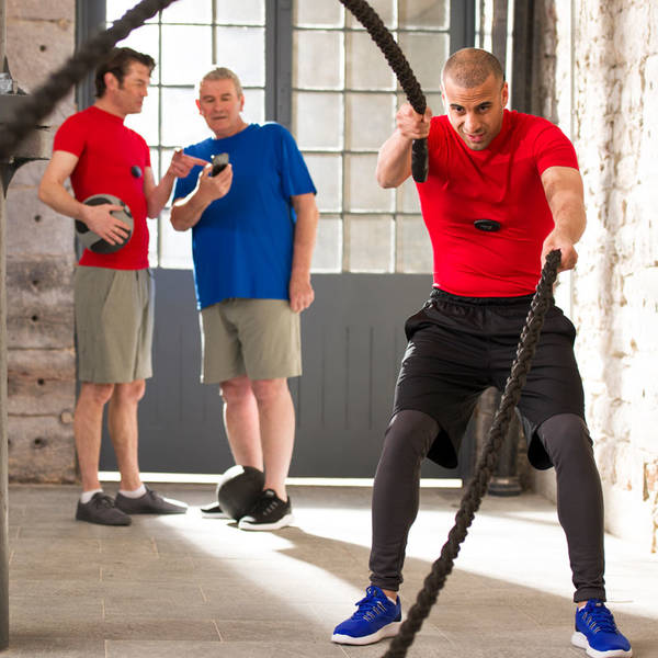 Fitness First member battle rope exercising Fitness First member battle rope exercising