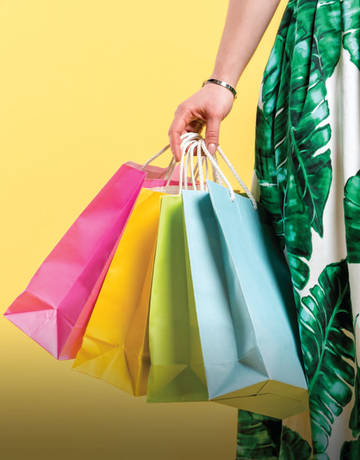 Lady holding bags after shopping using Good Vibes app