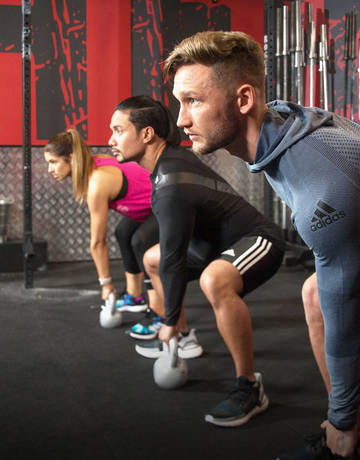 Fitness First members exercising using kettle bell