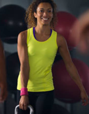 Gym member kettle-bell exercise